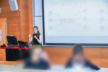 Eugenie presenting in front of an audience